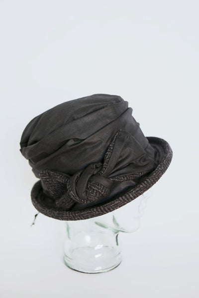 Traditional Irish tweed and wax cotton hat on glass display