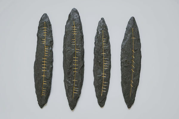 Four traditional dark grey slate wall hangings with Irish Ogham script in gold