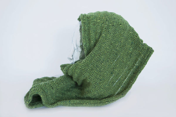 100% Irish Tweed handmade green scarf draped on glass display unit